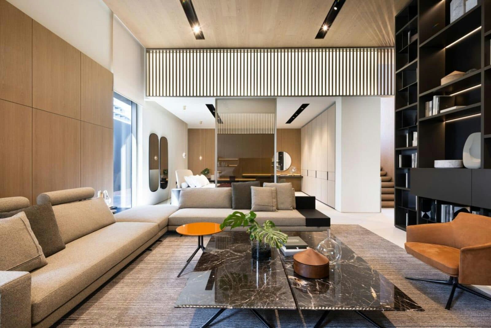 Strak zakelijk interieur met houtlook wandpanelen, marmerlook salontafel en loungemeubels.